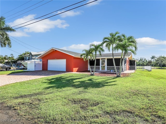 ranch-style home featuring a front yard, decorative driveway, and fence