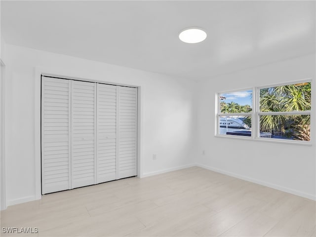 unfurnished bedroom featuring a closet and baseboards