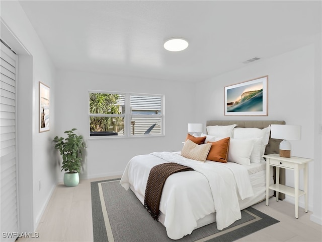 bedroom featuring visible vents and baseboards