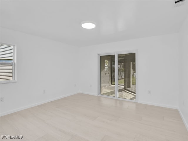 spare room featuring visible vents, baseboards, and a wealth of natural light