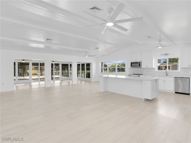 unfurnished living room with visible vents, vaulted ceiling with beams, and a ceiling fan