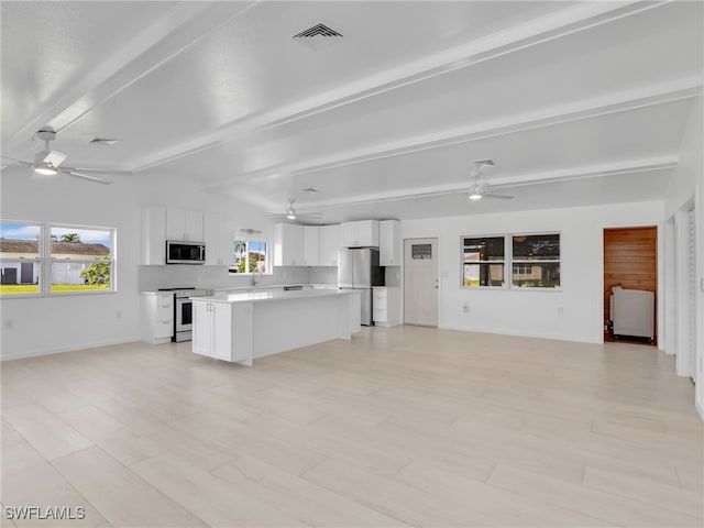 kitchen with open floor plan, appliances with stainless steel finishes, and ceiling fan