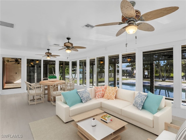 sunroom / solarium featuring visible vents and a ceiling fan