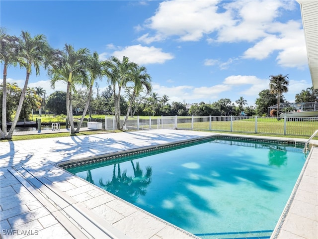 view of swimming pool with a fenced in pool, a patio area, a lawn, and fence