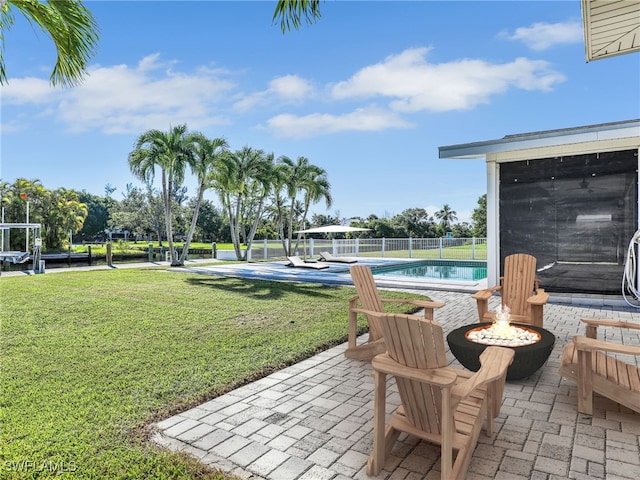 view of patio / terrace featuring a fenced in pool, fence, and an outdoor fire pit