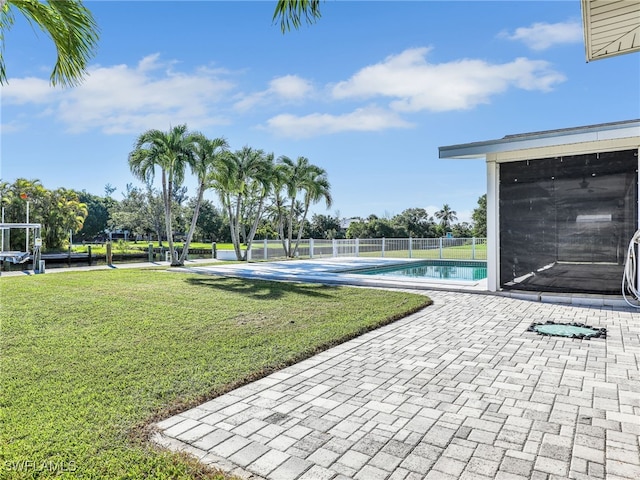 view of pool featuring a fenced in pool, a patio, a lawn, and fence