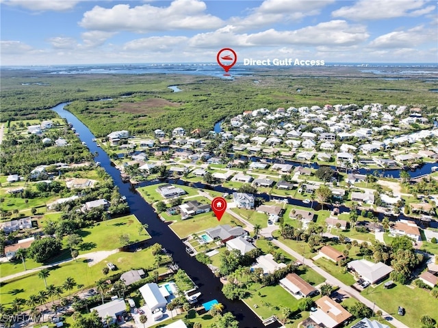 drone / aerial view featuring a water view and a residential view