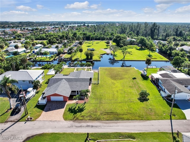 drone / aerial view with a water view and a residential view