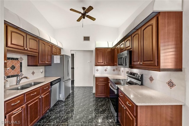 kitchen with decorative backsplash, appliances with stainless steel finishes, ceiling fan, and sink