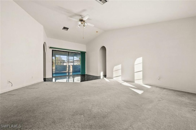 empty room featuring carpet flooring, ceiling fan, and vaulted ceiling