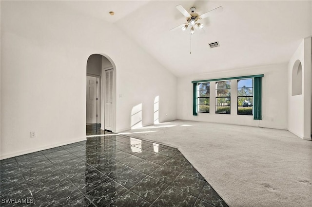 unfurnished living room featuring ceiling fan, high vaulted ceiling, and dark carpet