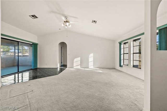 carpeted empty room with ceiling fan and vaulted ceiling