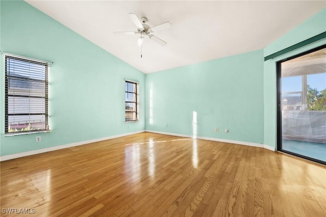 spare room featuring ceiling fan, vaulted ceiling, and light wood-type flooring