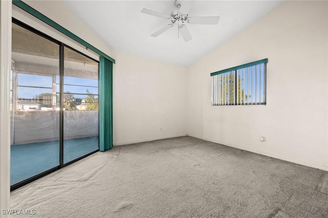 carpeted spare room featuring ceiling fan and vaulted ceiling