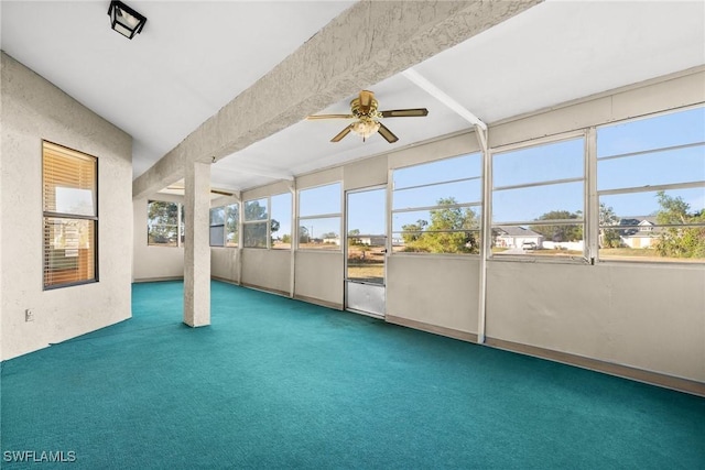 unfurnished sunroom with ceiling fan and beamed ceiling