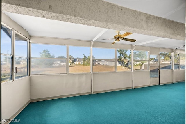 unfurnished sunroom featuring a wealth of natural light and ceiling fan