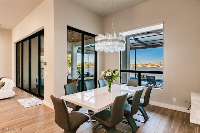 dining area featuring hardwood / wood-style floors and a notable chandelier