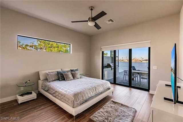 bedroom featuring access to outside, multiple windows, ceiling fan, and hardwood / wood-style flooring