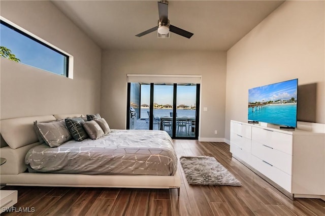 bedroom with hardwood / wood-style flooring, ceiling fan, access to outside, and multiple windows