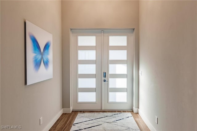 entryway with wood-type flooring and french doors