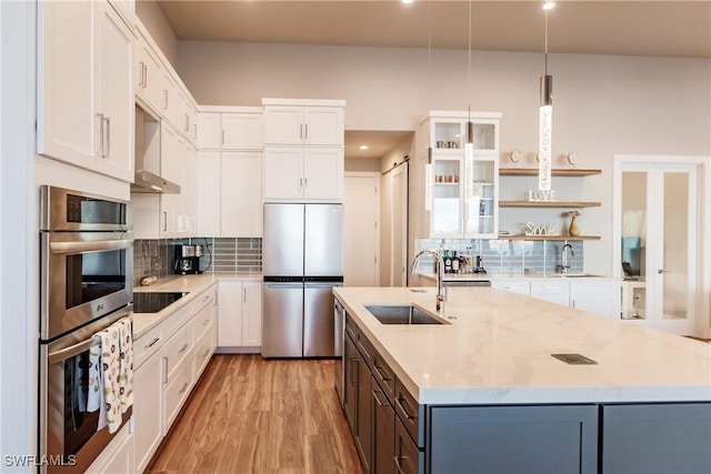 kitchen with white cabinets, decorative light fixtures, and stainless steel appliances