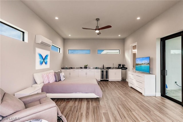 bedroom featuring ceiling fan, light wood-type flooring, beverage cooler, and a wall mounted AC