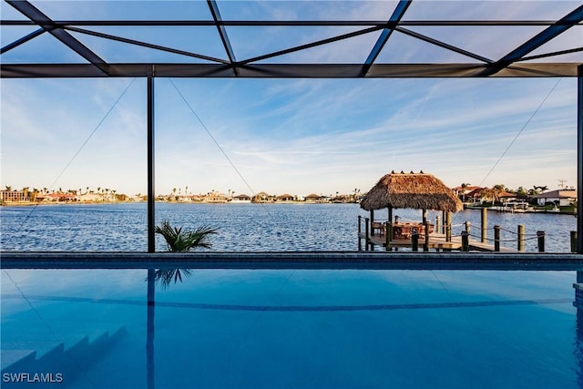 view of pool featuring a water view and a dock