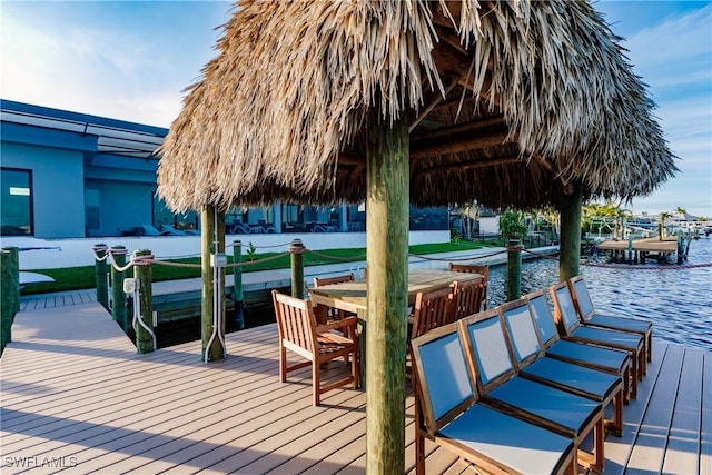 view of dock featuring a gazebo and a water view