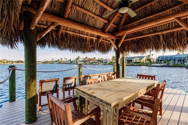 view of dock featuring a gazebo and a water view