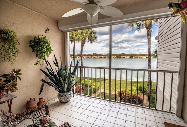 sunroom with a water view, plenty of natural light, and ceiling fan