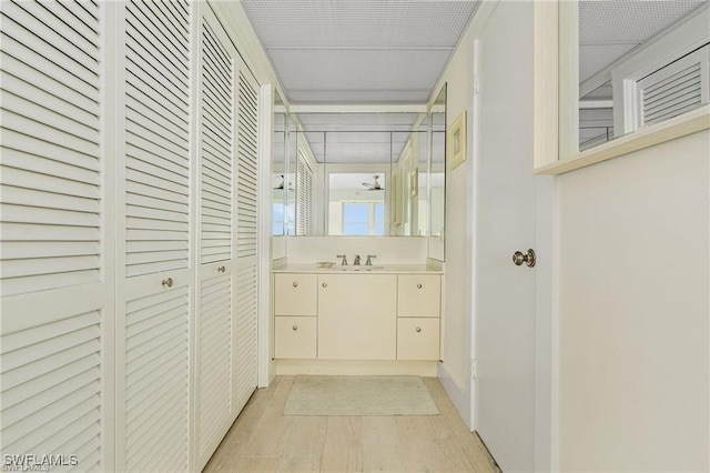 bathroom with ceiling fan and vanity