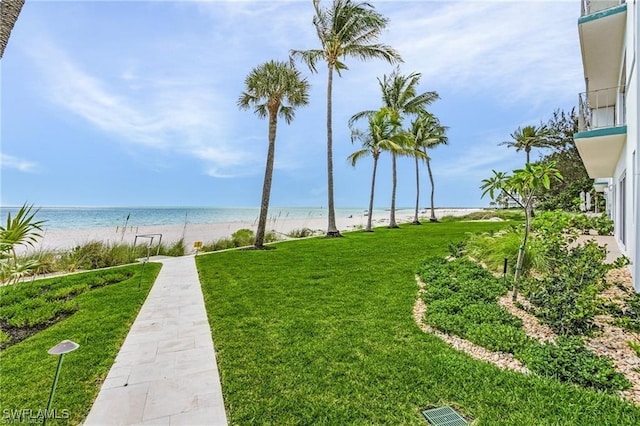 view of yard featuring a view of the beach and a water view