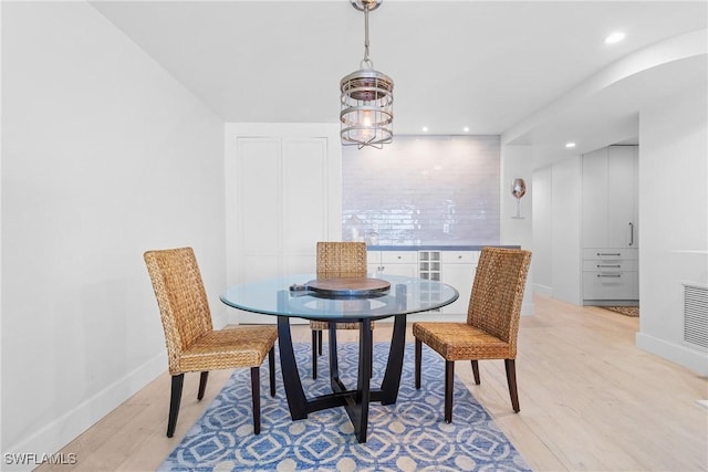 dining space with light hardwood / wood-style floors