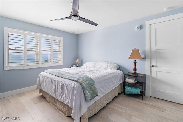 bedroom with ceiling fan and light hardwood / wood-style floors