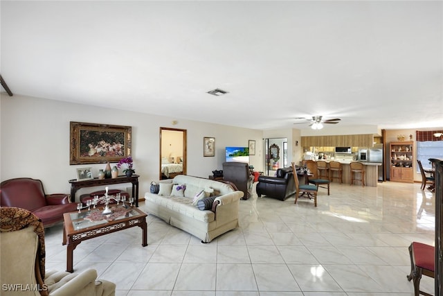 9940 Vanderbilt Dr, Naples, FL 34108 - living area featuring a ceiling fan, light tile patterned floors, and visible vents