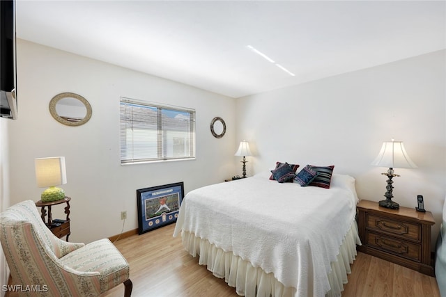 9940 Vanderbilt Dr, Naples, FL 34108 - bedroom featuring baseboards and light wood-style floors