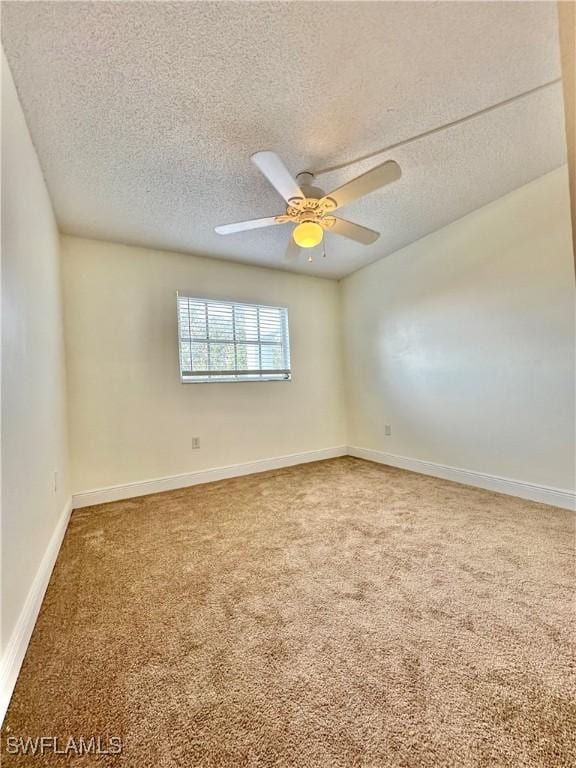 spare room with carpet, a textured ceiling, and ceiling fan