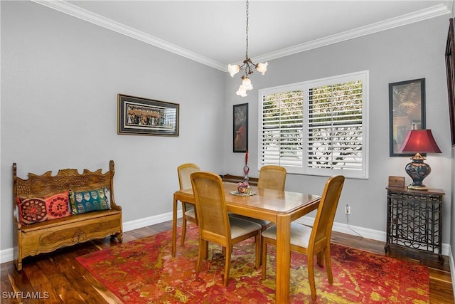 dining room with dark hardwood / wood-style flooring, crown molding, and a chandelier