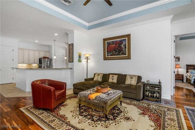 living room featuring crown molding, ceiling fan, and dark hardwood / wood-style flooring