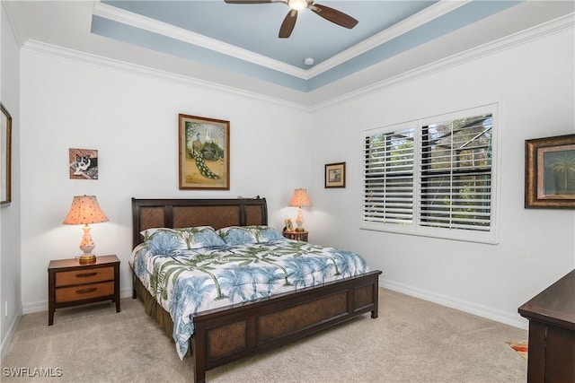 carpeted bedroom with ornamental molding, a raised ceiling, and ceiling fan