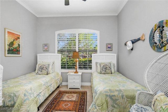 carpeted bedroom featuring ornamental molding and ceiling fan