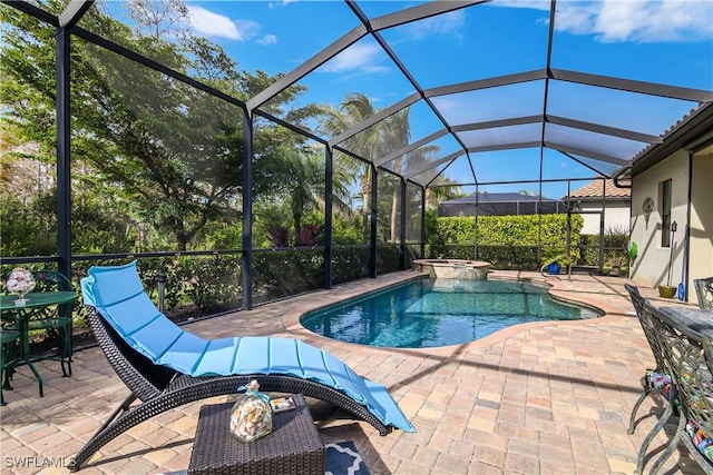 view of swimming pool with an in ground hot tub, glass enclosure, and a patio