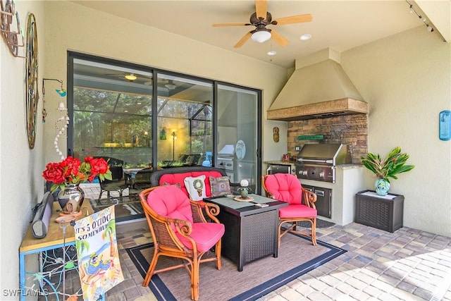 view of patio / terrace featuring exterior kitchen, a grill, and ceiling fan