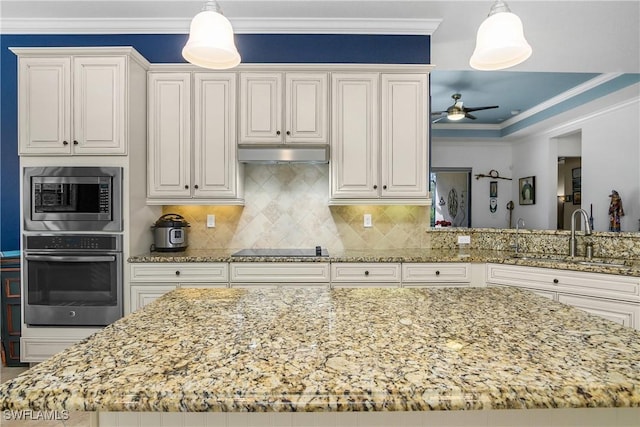 kitchen featuring sink, ornamental molding, appliances with stainless steel finishes, and hanging light fixtures