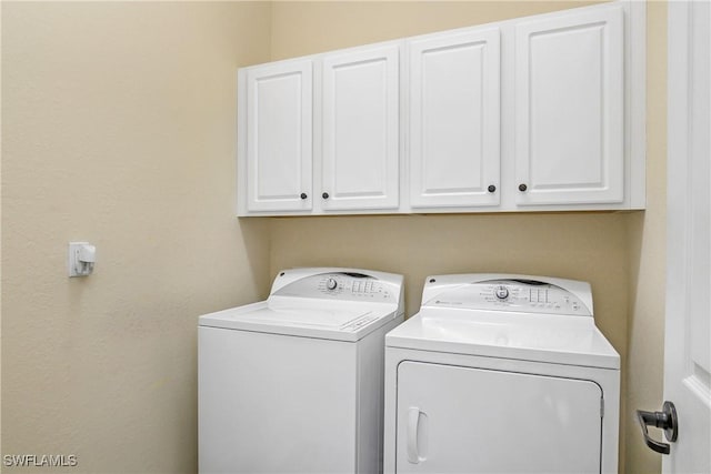 washroom with cabinets and separate washer and dryer