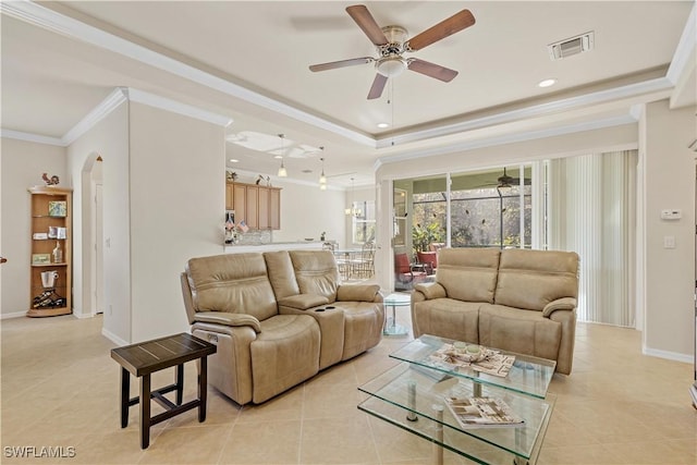 tiled living room with ceiling fan and ornamental molding