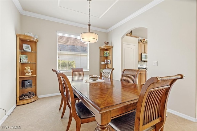 dining space with light tile patterned floors and ornamental molding