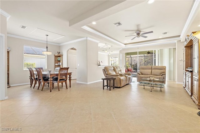 interior space featuring a tray ceiling, a wealth of natural light, ceiling fan, and ornamental molding