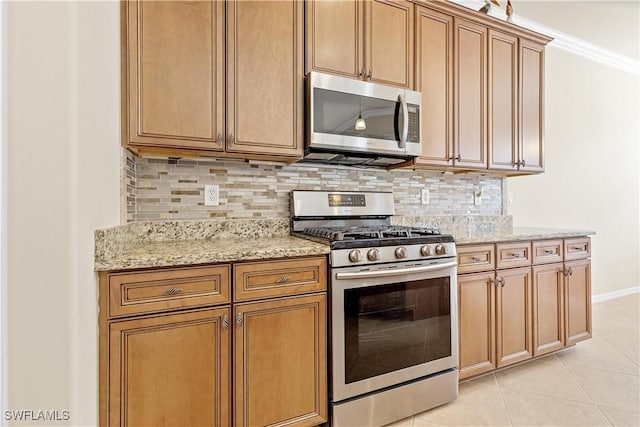 kitchen featuring light stone counters, crown molding, decorative backsplash, light tile patterned flooring, and appliances with stainless steel finishes