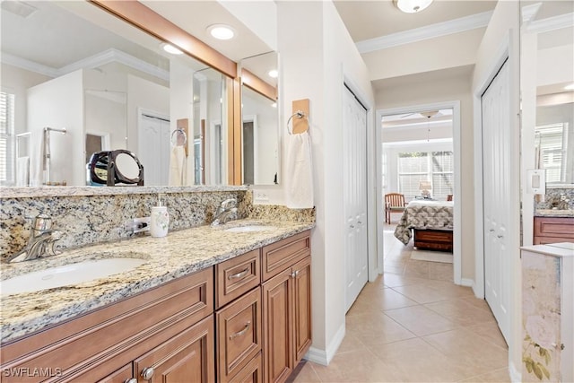 bathroom with tile patterned flooring, vanity, tasteful backsplash, and ornamental molding